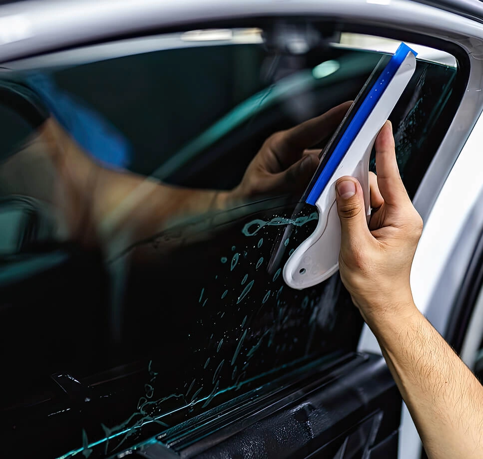 Homem fazendo limpeza em uma carro branco